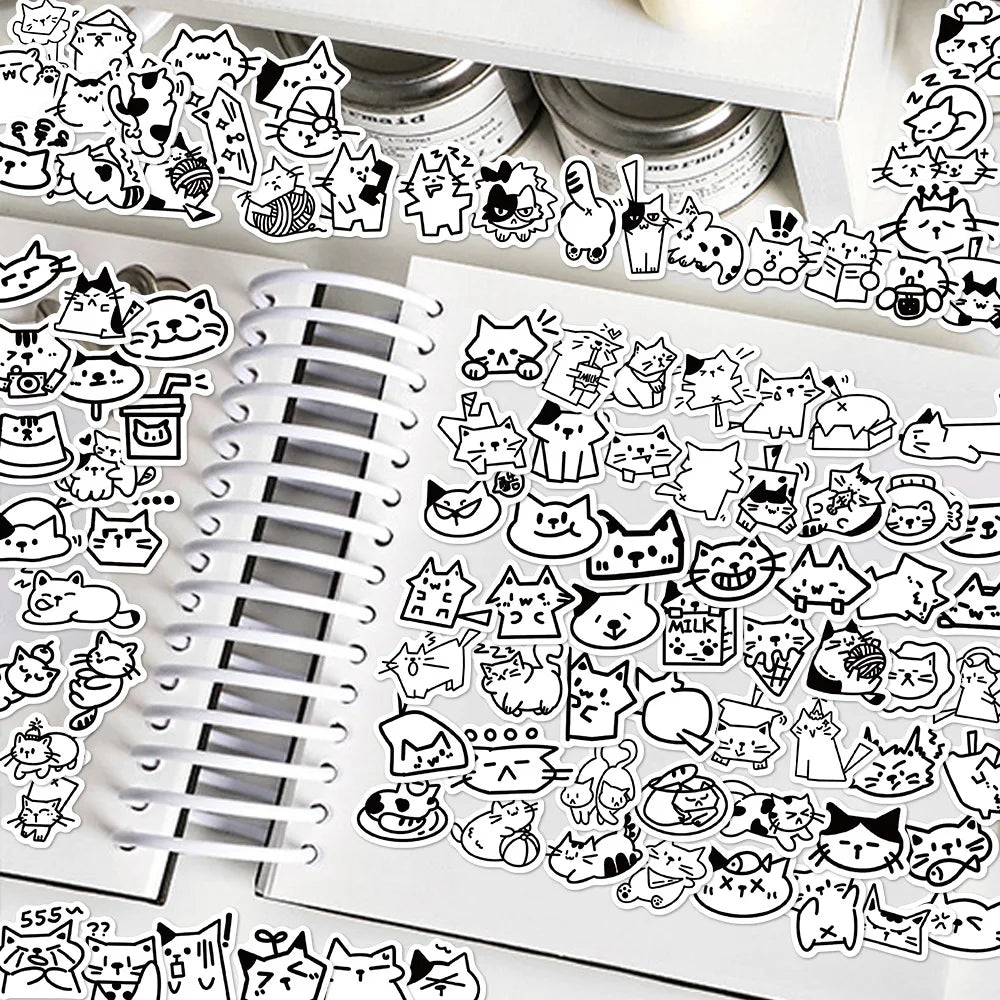 100Pcs de stickers de gatos kawaii en un cuaderno, con diseños adorables y variados para personalizar objetos.